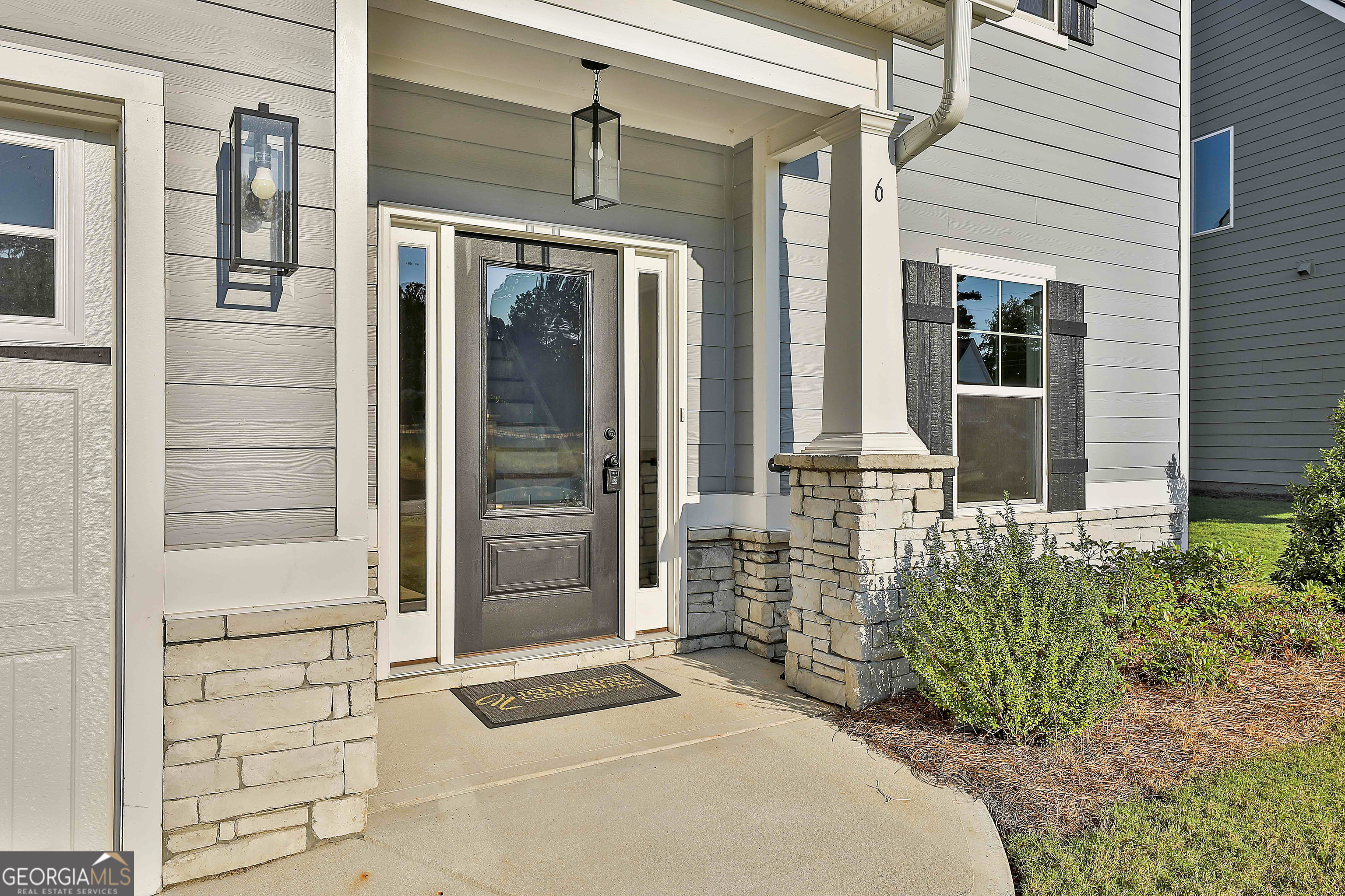 6 Leverett Drive, Unit 17 Newnan, GA 30265 - Photo 4 of 35 a front view of a house with a glass door