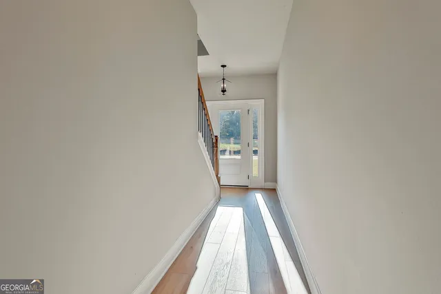 a view of a hallway with wooden floor
