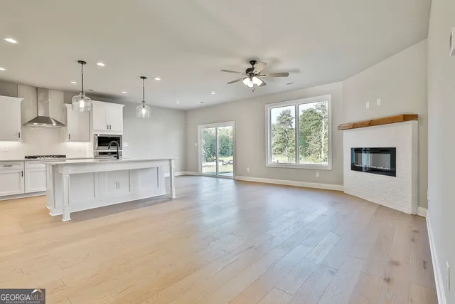 a view of kitchen with granite countertop stove top oven and cabinets