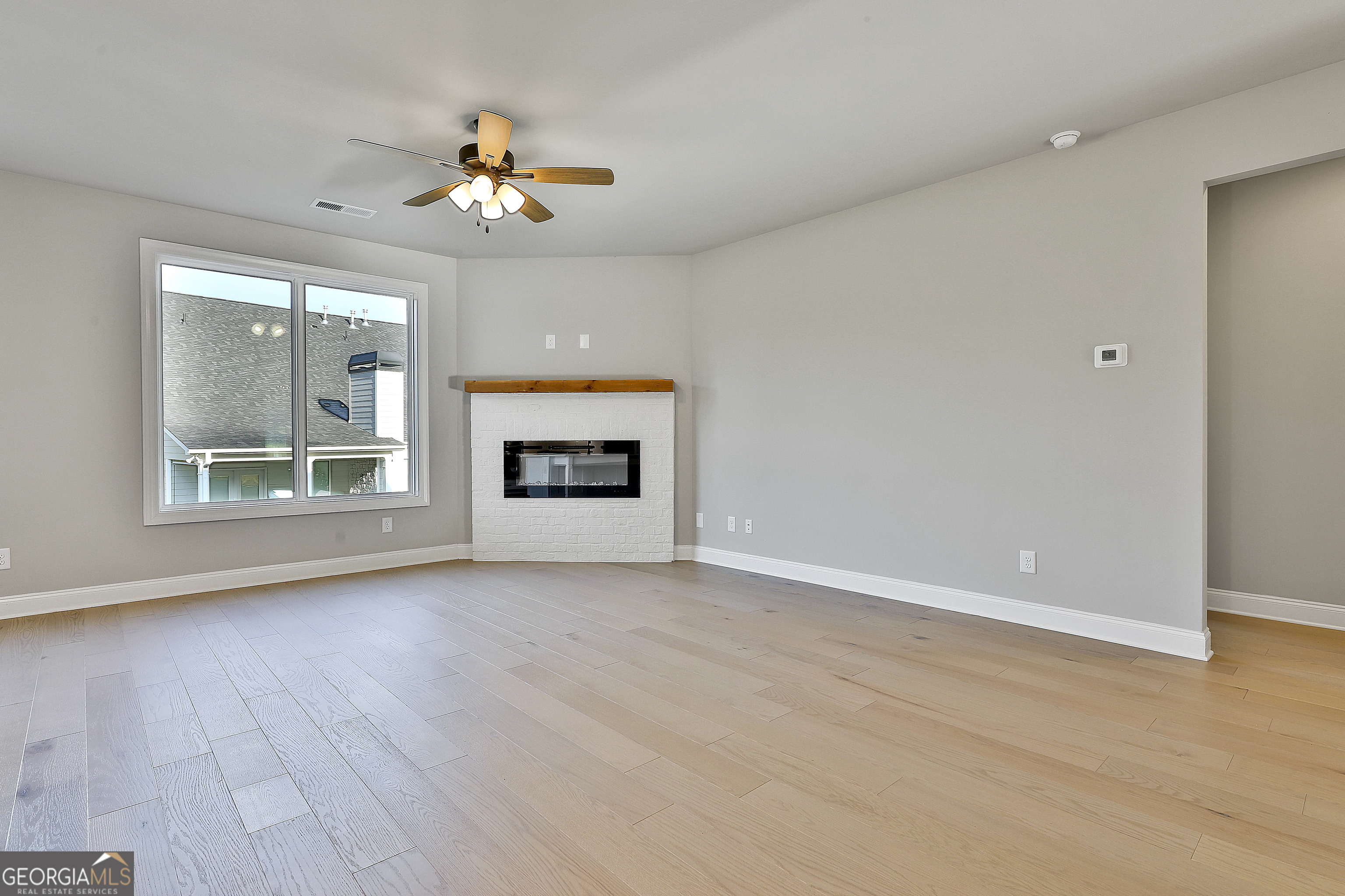 6 Leverett Drive, Unit 17 Newnan, GA 30265 - Photo 9 of 35 a view of empty room with wooden floor and fan