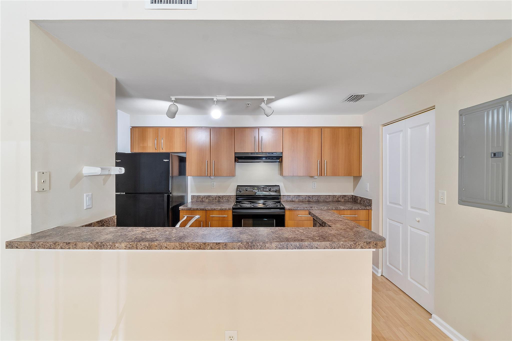 6020 West Sample Road, Unit 103 Coral Springs, FL 33067 - Photo 7 of 20 a kitchen with a stove and a refrigerator