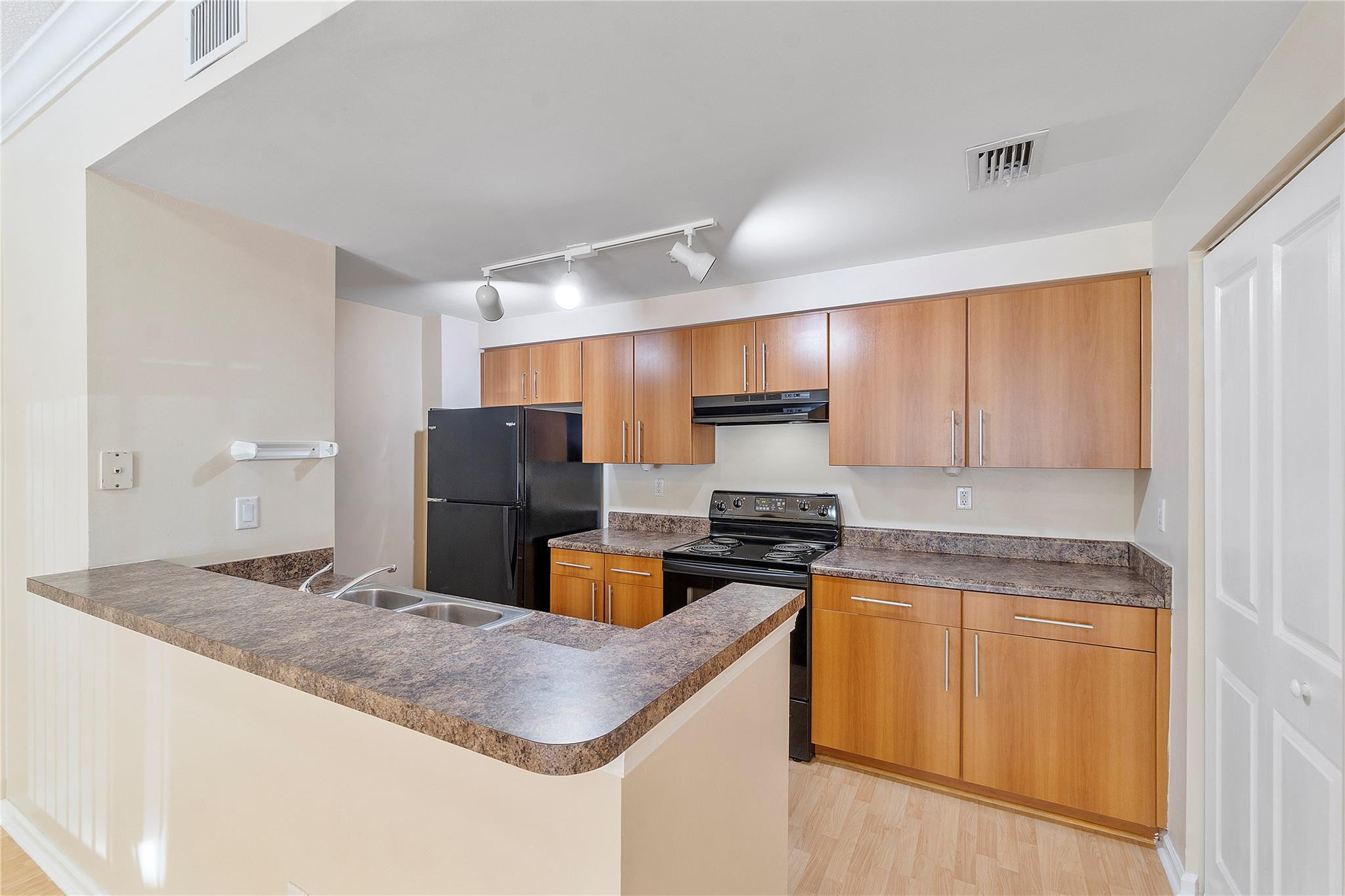 6020 West Sample Road, Unit 103 Coral Springs, FL 33067 - Photo 8 of 20 a kitchen with stainless steel appliances granite countertop a sink stove and refrigerator