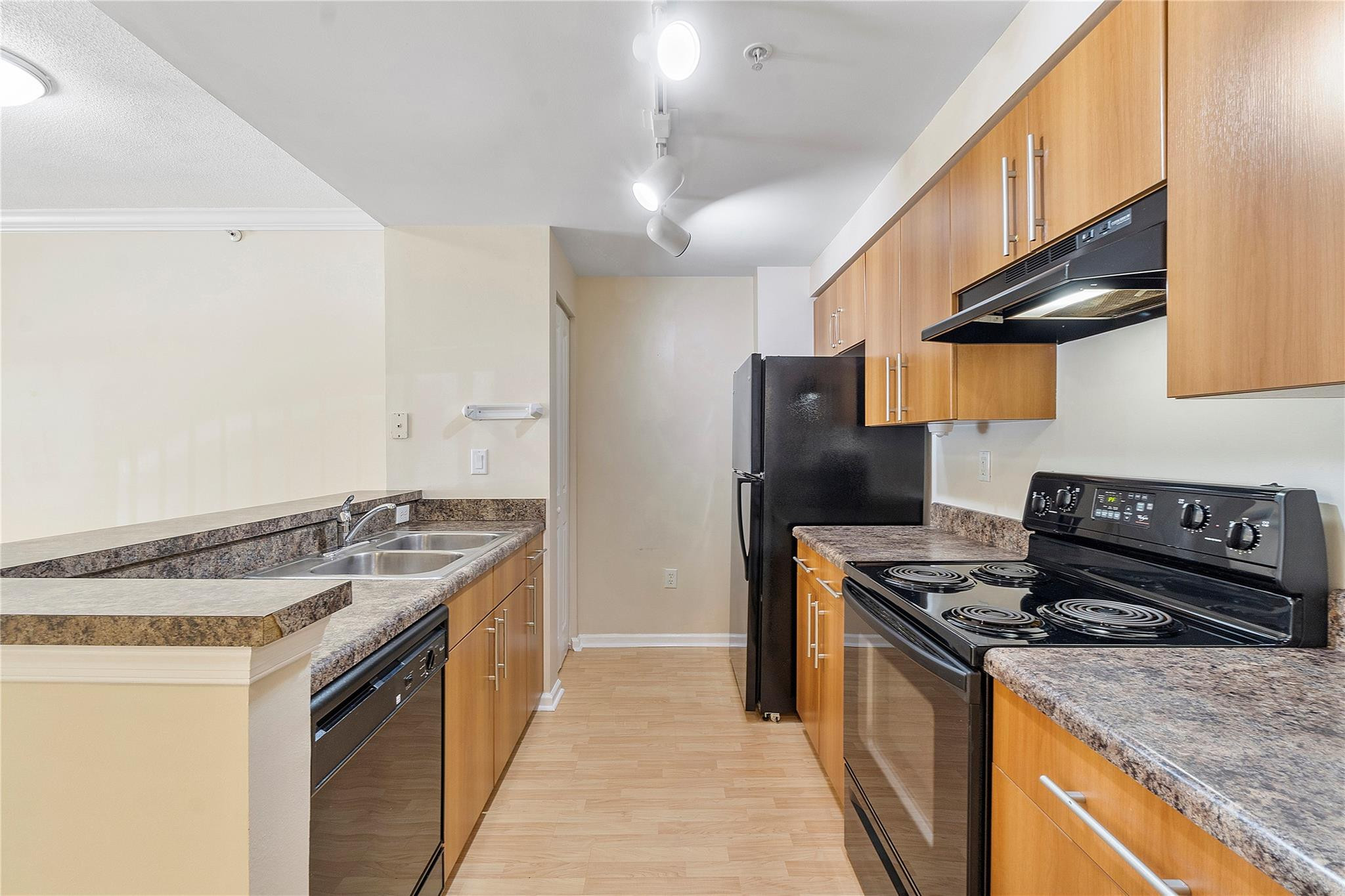 6020 West Sample Road, Unit 103 Coral Springs, FL 33067 - Photo 10 of 20 a kitchen with stainless steel appliances granite countertop a stove and a sink