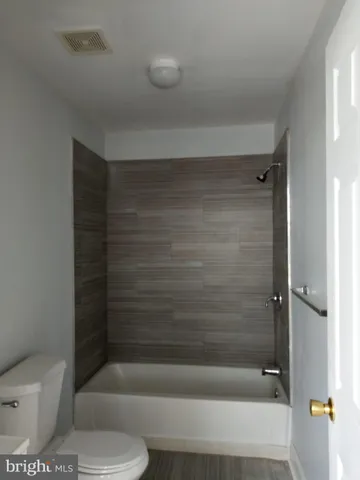 a bathroom with a toilet and a bathtub
