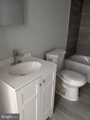 a white toilet sitting next to a bathroom sink