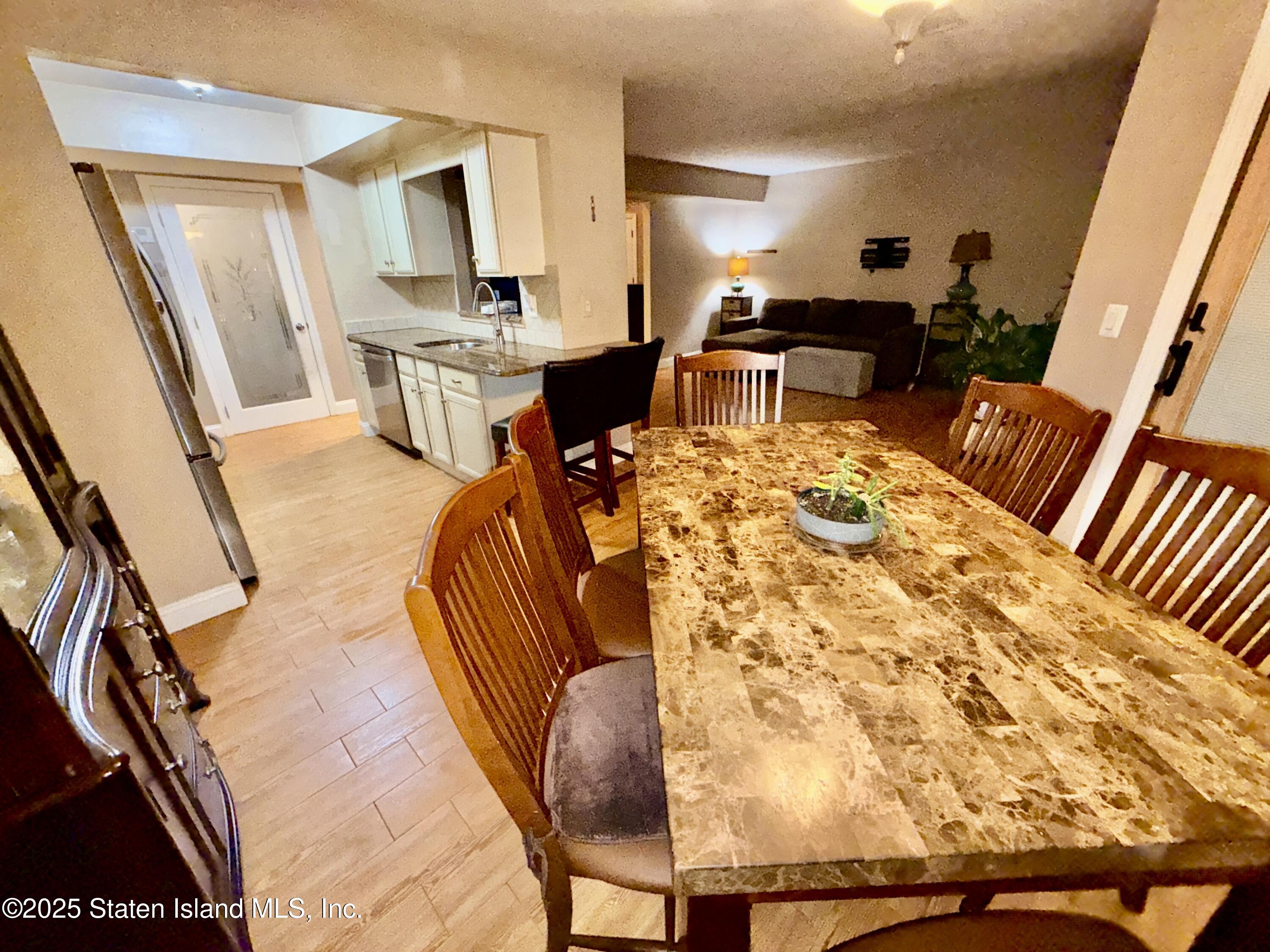 1446 Forest Hill Road, Unit 4 Staten Island, NY 10314 - Photo 11 of 24 a living room with furniture a rug and white walls