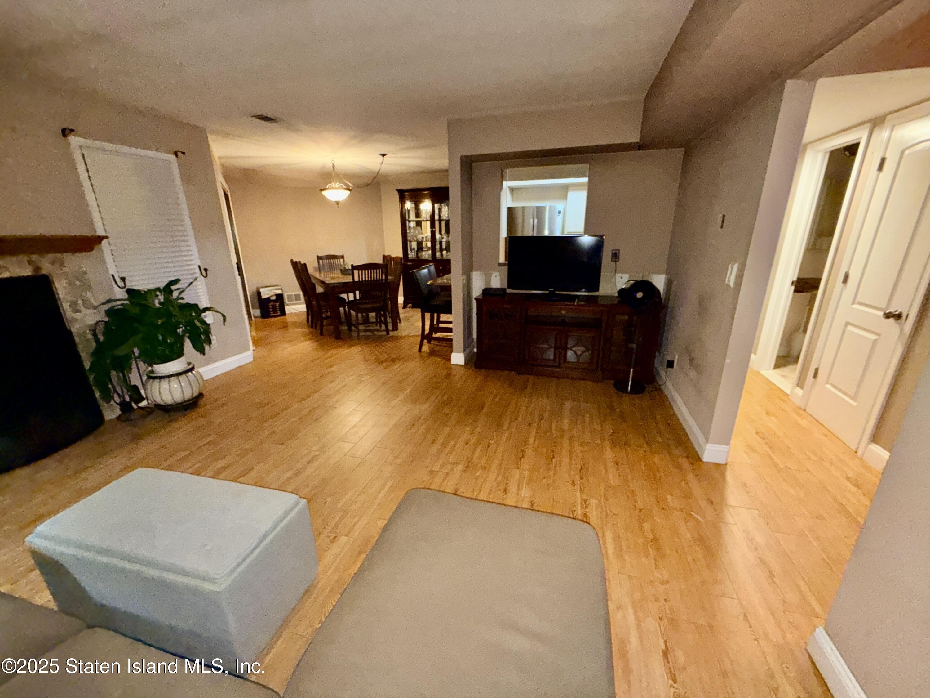 1446 Forest Hill Road, Unit 4 Staten Island, NY 10314 - Photo 15 of 24 a living room with furniture and a flat screen tv