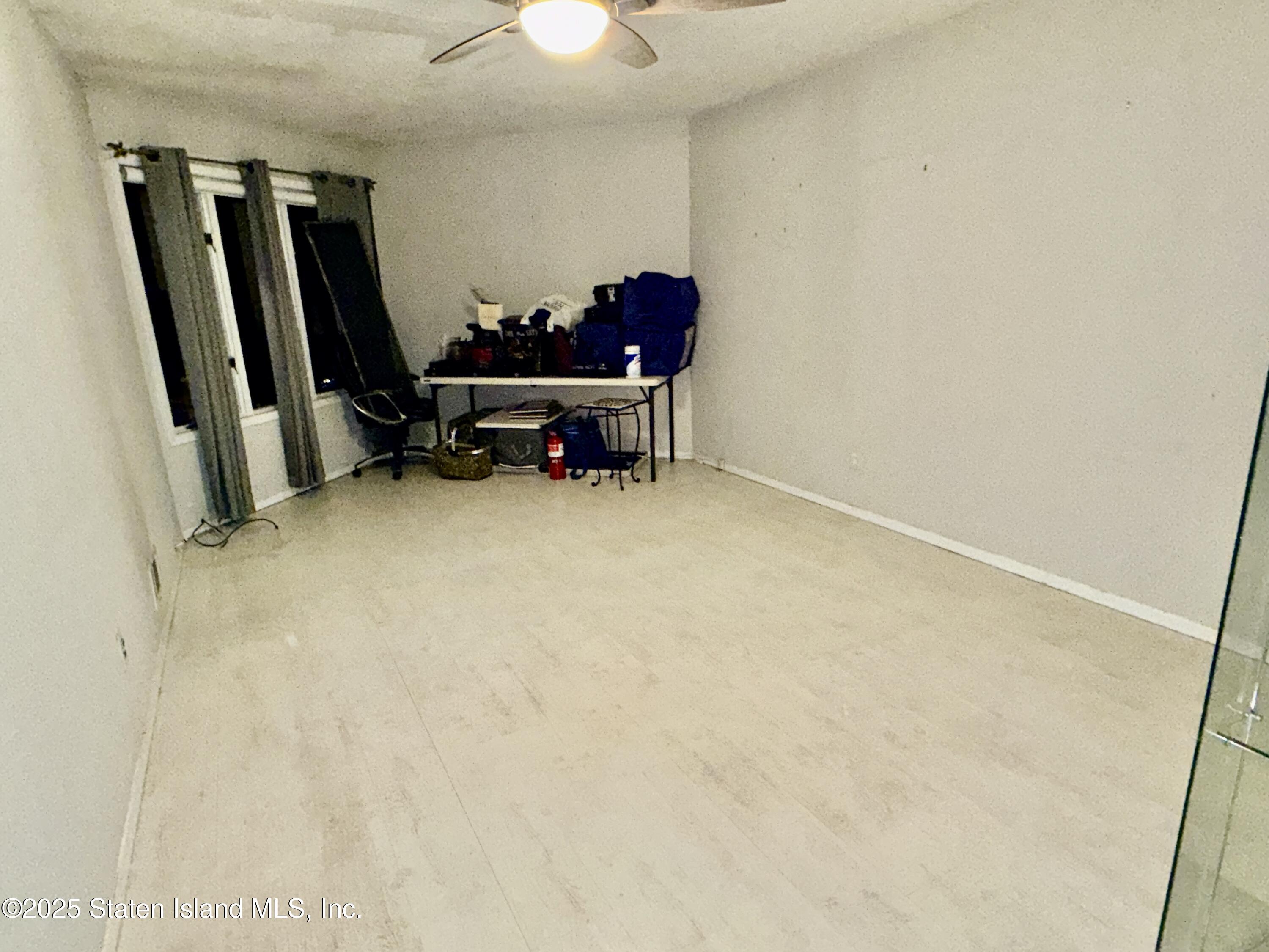 1446 Forest Hill Road, Unit 4 Staten Island, NY 10314 - Photo 17 of 24 a view of room with furniture and a flat screen tv