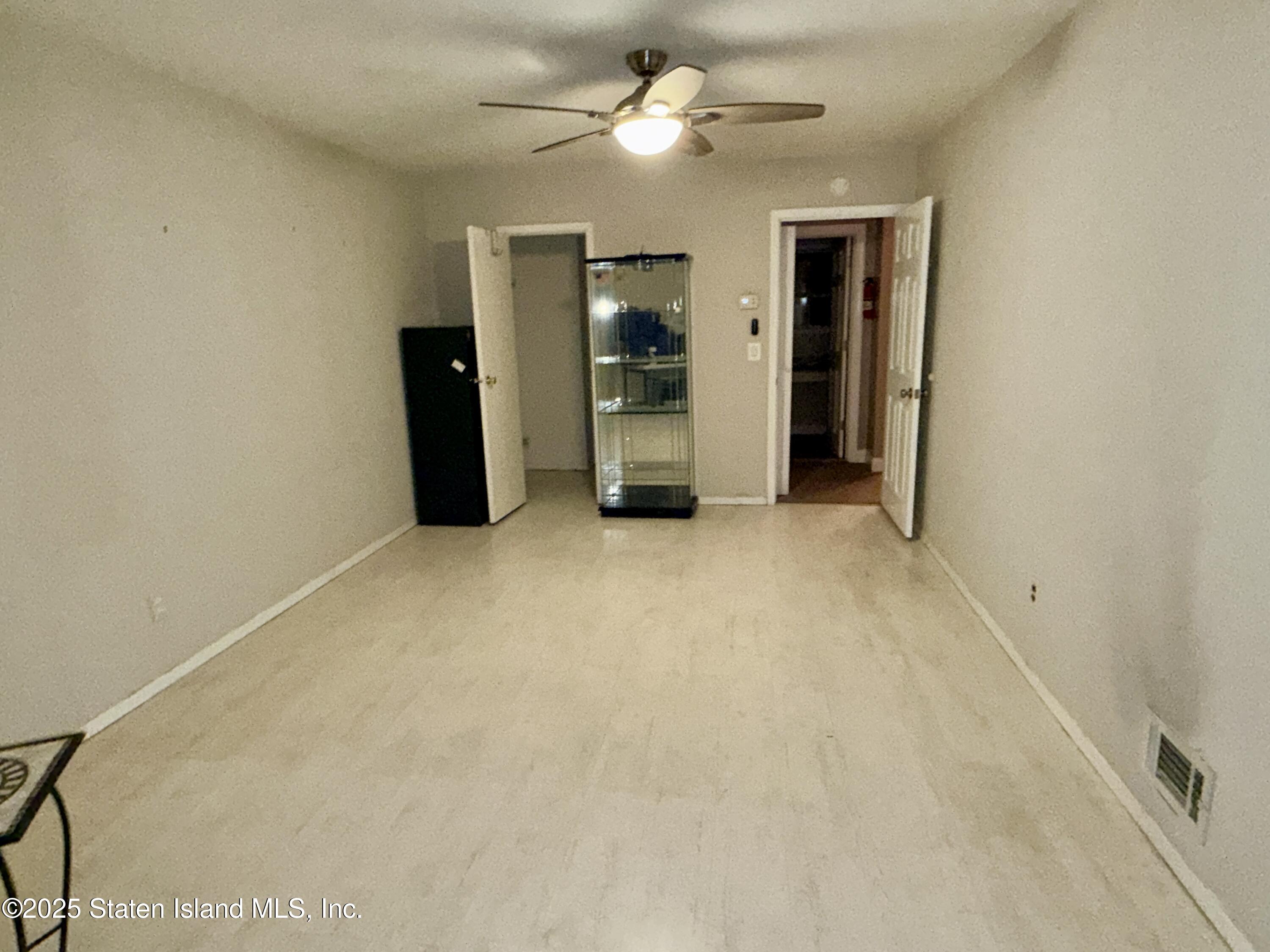 1446 Forest Hill Road, Unit 4 Staten Island, NY 10314 - Photo 18 of 24 an empty room with closet and a ceiling fan