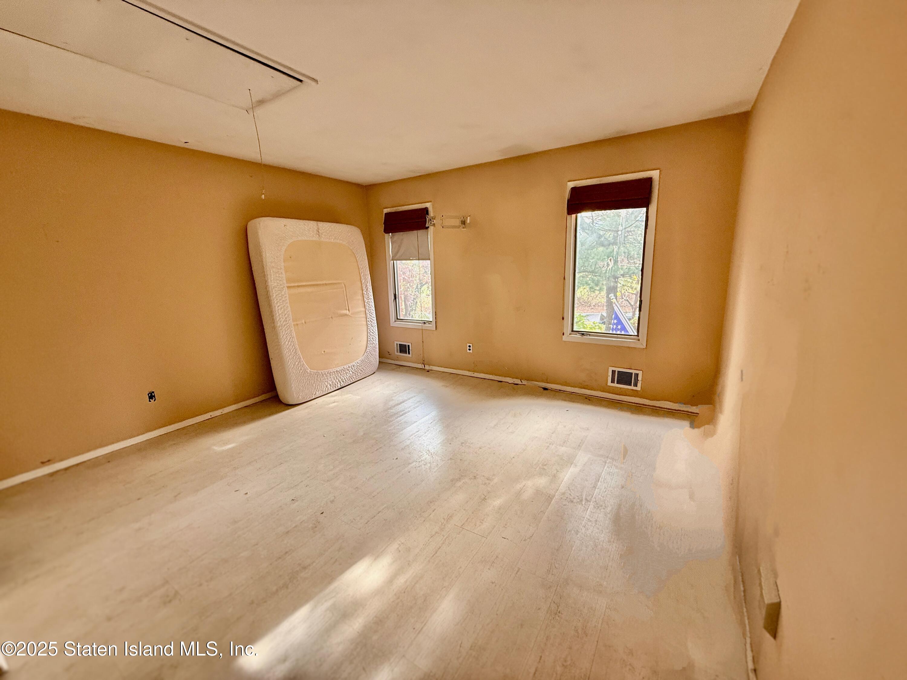 1446 Forest Hill Road, Unit 4 Staten Island, NY 10314 - Photo 20 of 24 a view of an empty room with a window