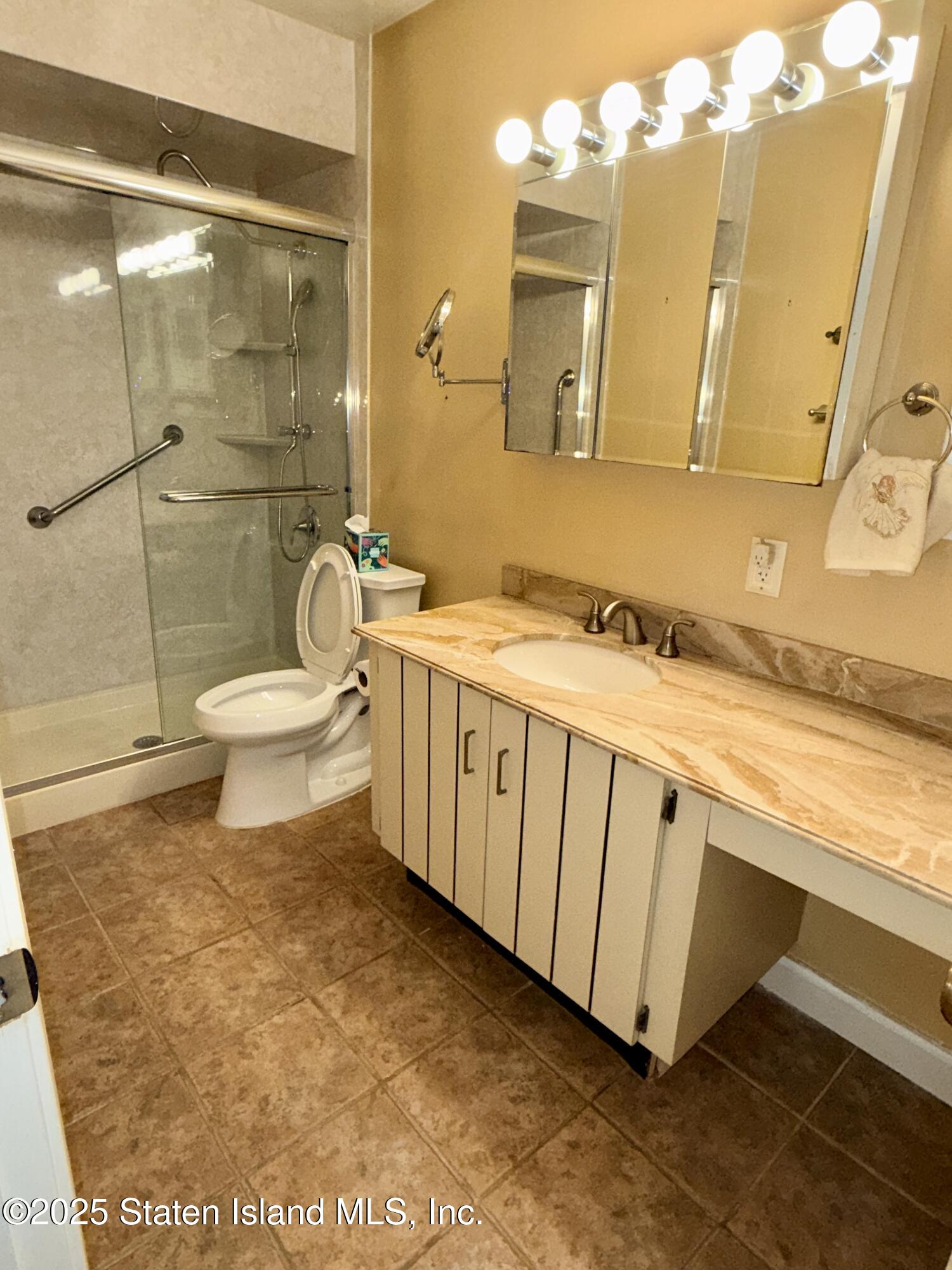 1446 Forest Hill Road, Unit 4 Staten Island, NY 10314 - Photo 22 of 24 a bathroom with a sink a toilet and shower