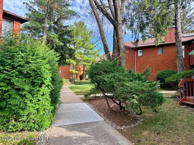 a view of a pathway both side of a house