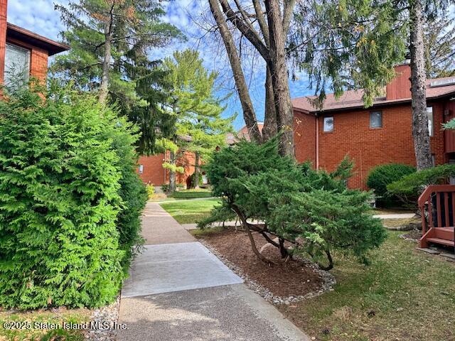 1446 Forest Hill Road, Unit 4 Staten Island, NY 10314 - Photo 3 of 24 a view of a pathway both side of a house