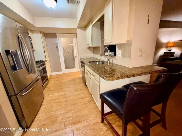 a kitchen with sink cabinets and wooden floor