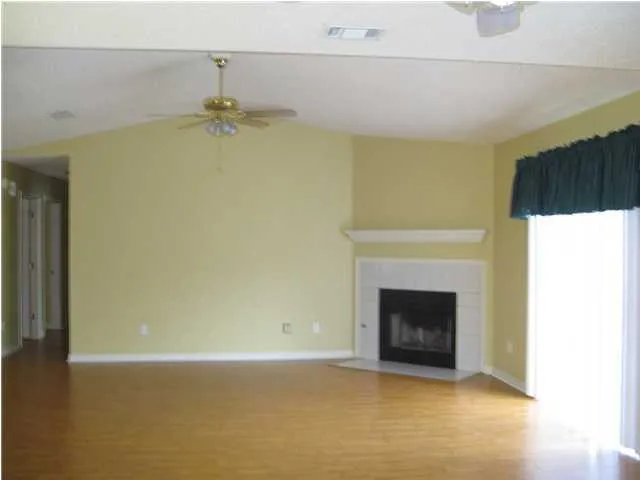 a view of empty room with a fireplace