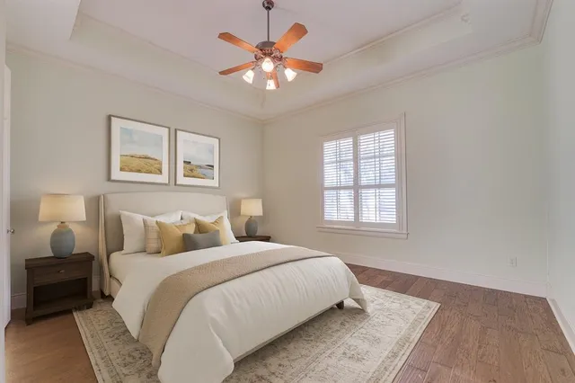 a bedroom with a large bed and a chandelier
