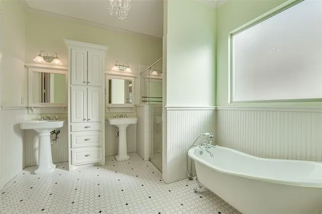 a bathroom with a bathtub sink and mirror