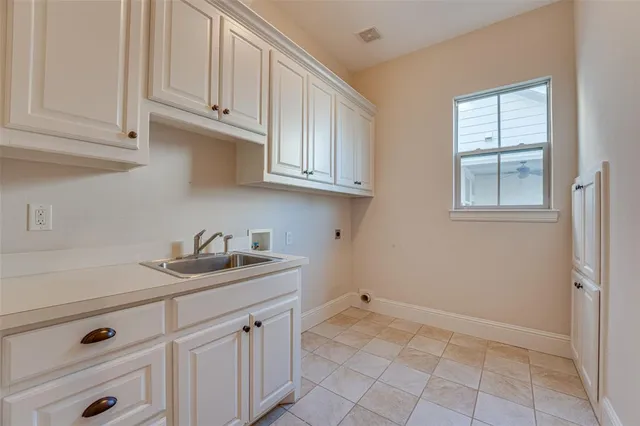 a kitchen with white cabinets and a sink