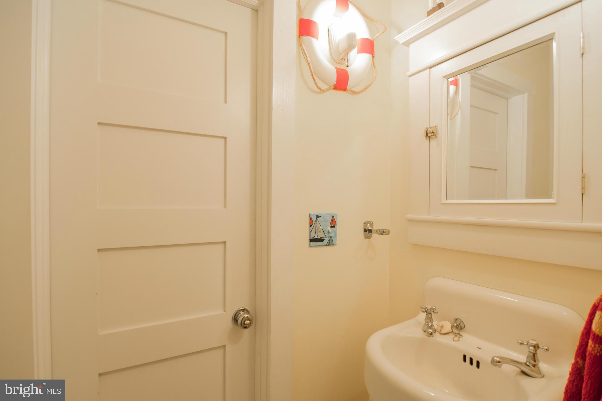 4028 Chesapeake Drive Edgewater, MD 21037 - Photo 24 of 30 a bathroom with a sink and a mirror