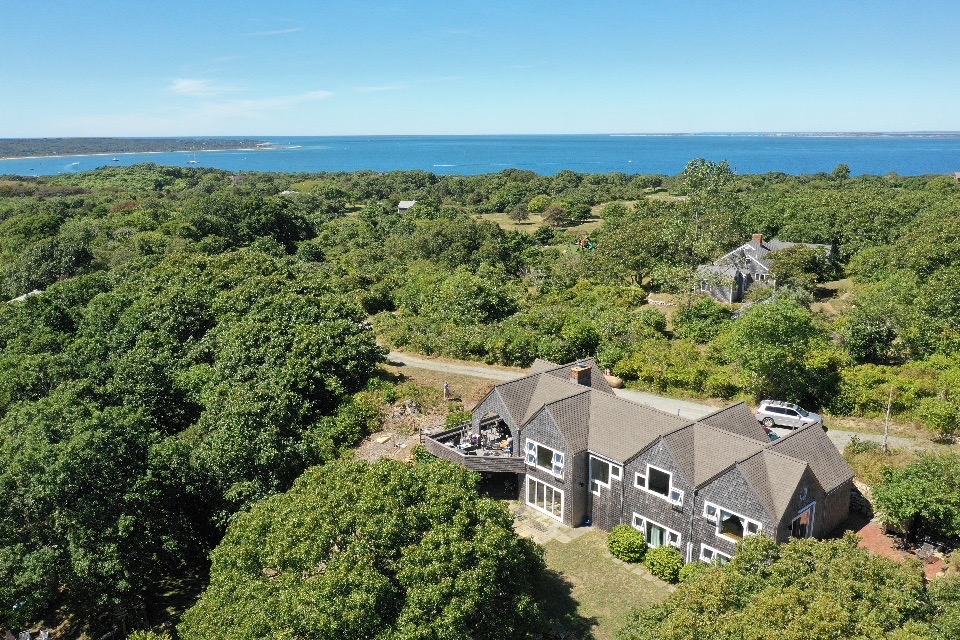an aerial view of a house with a yard