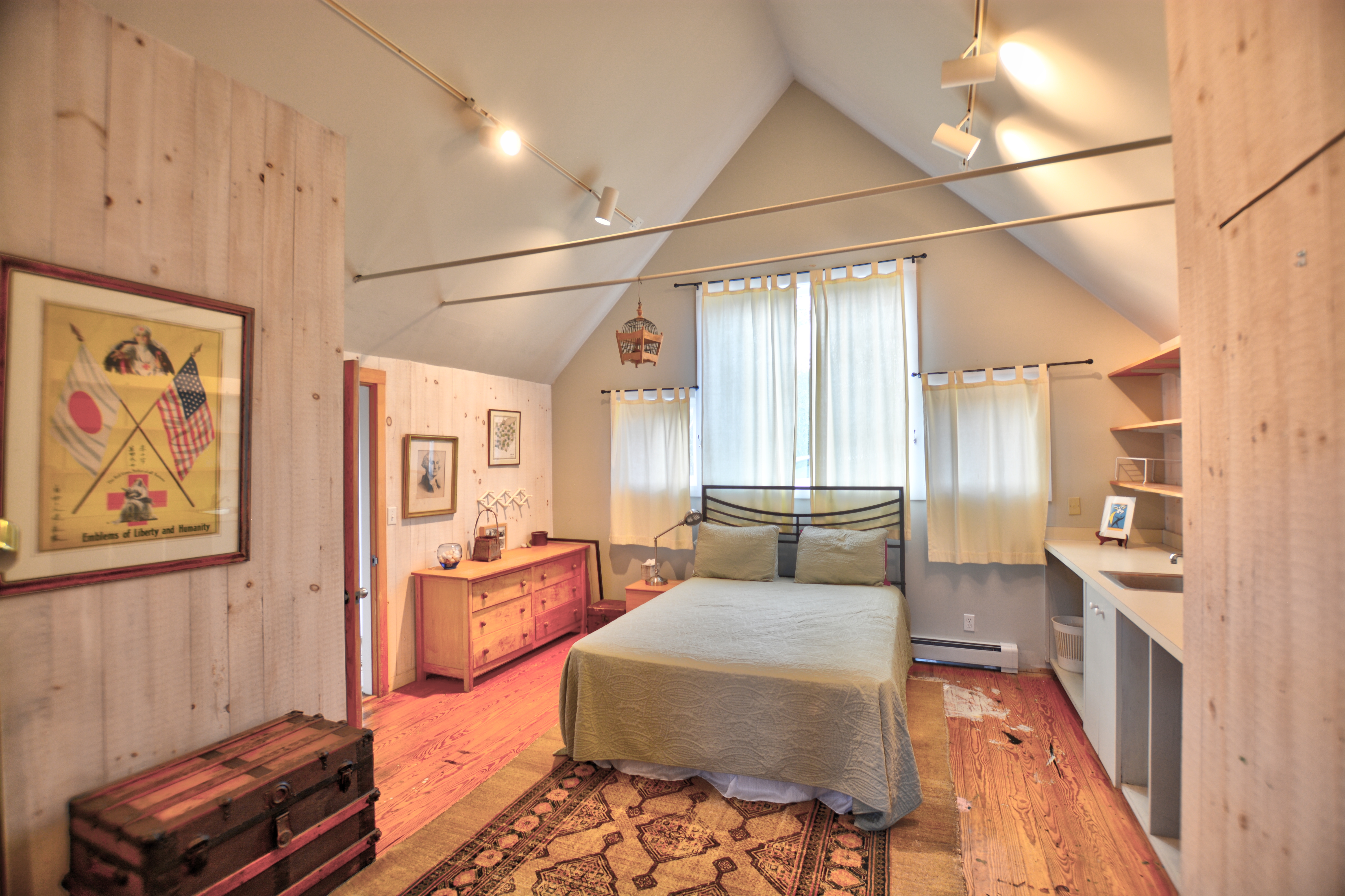13 Kapigan Road Chilmark, MA 02535 - Photo 18 of 25 a bedroom with a bed and wooden floor