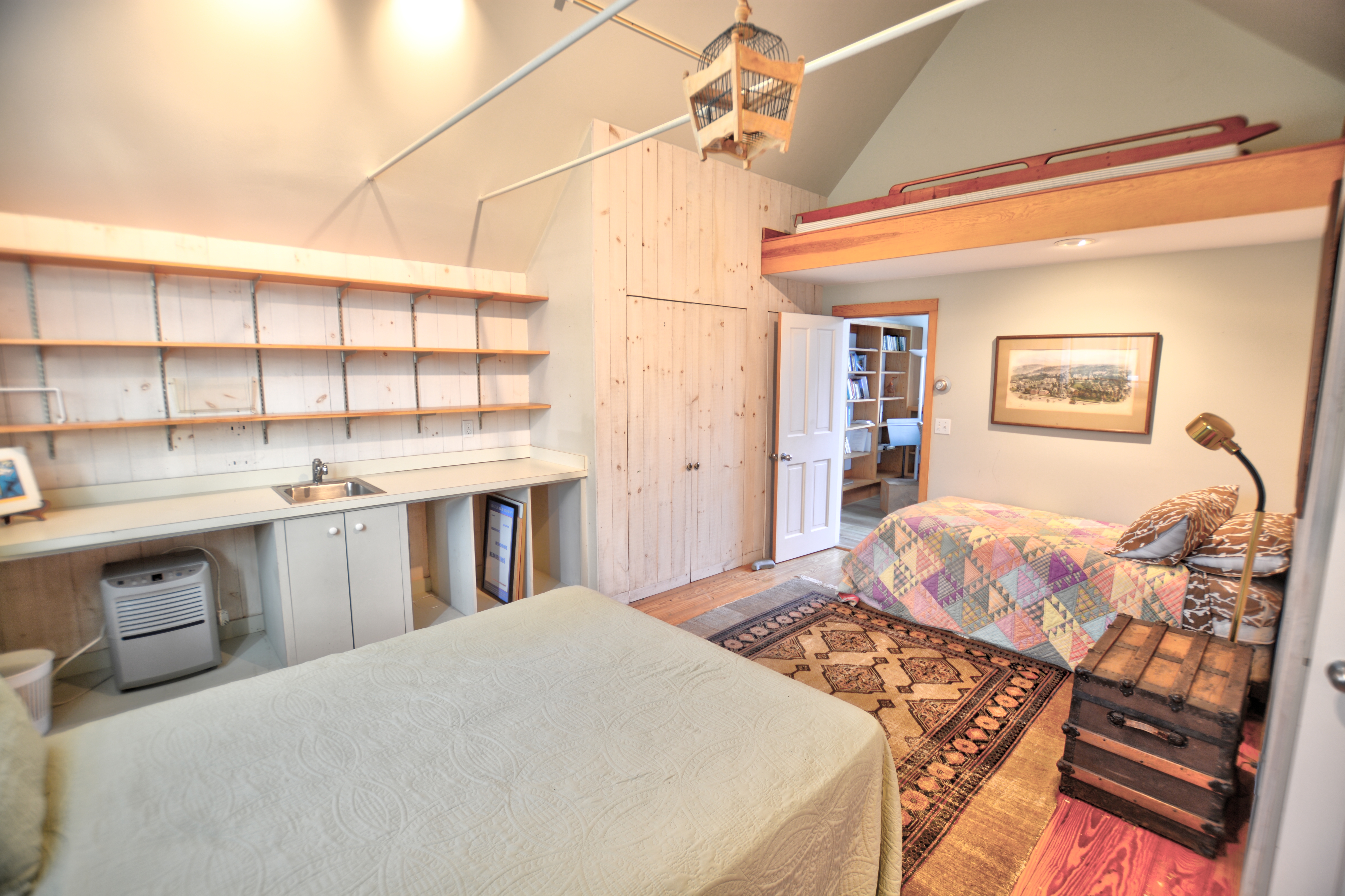 13 Kapigan Road Chilmark, MA 02535 - Photo 21 of 25 a bedroom with a large bed and a chandelier