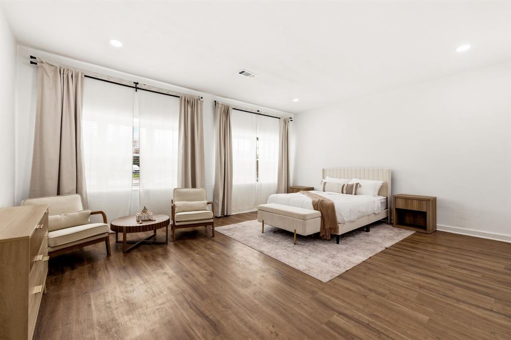 544 West Bethel Road Coppell, TX 75019 - Photo 12 of 19 a bedroom with a bed and wooden floor