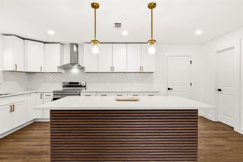 544 West Bethel Road Coppell, TX 75019 - Photo 4 of 19 a kitchen with a sink cabinets and wooden floor