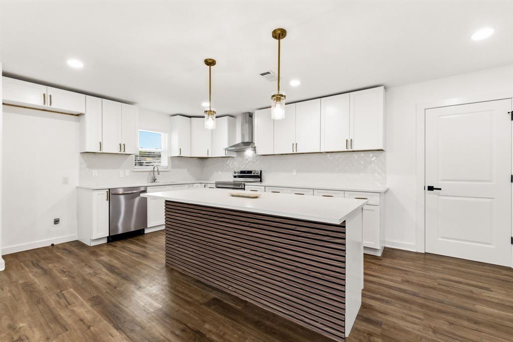 544 West Bethel Road Coppell, TX 75019 - Photo 5 of 19 a kitchen with stainless steel appliances granite countertop a sink a stove and white cabinets with wooden floor