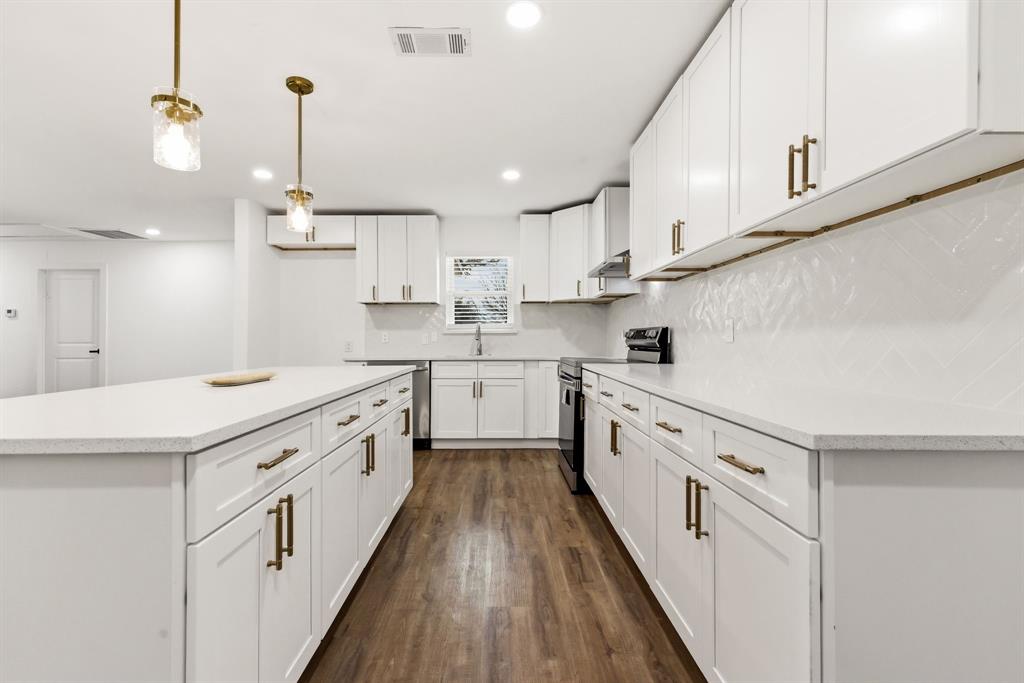 544 West Bethel Road Coppell, TX 75019 - Photo 6 of 19 a kitchen with granite countertop white cabinets and white appliances