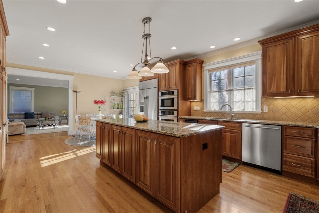 1682 Commonwealth Avenue Newton, MA 02465 - Photo 4 of 35 a kitchen with stainless steel appliances granite countertop a sink a stove and a wooden floors