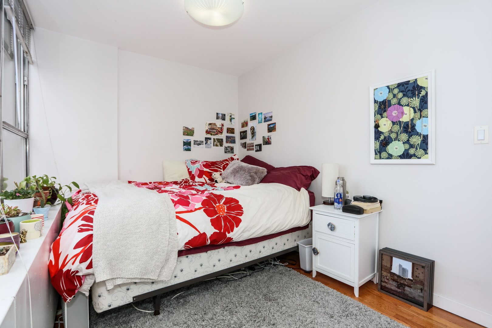 655 West Irving Park Road, Unit 1017 Chicago, IL 60613 - Photo 12 of 24 a bedroom with a bed and wooden floor