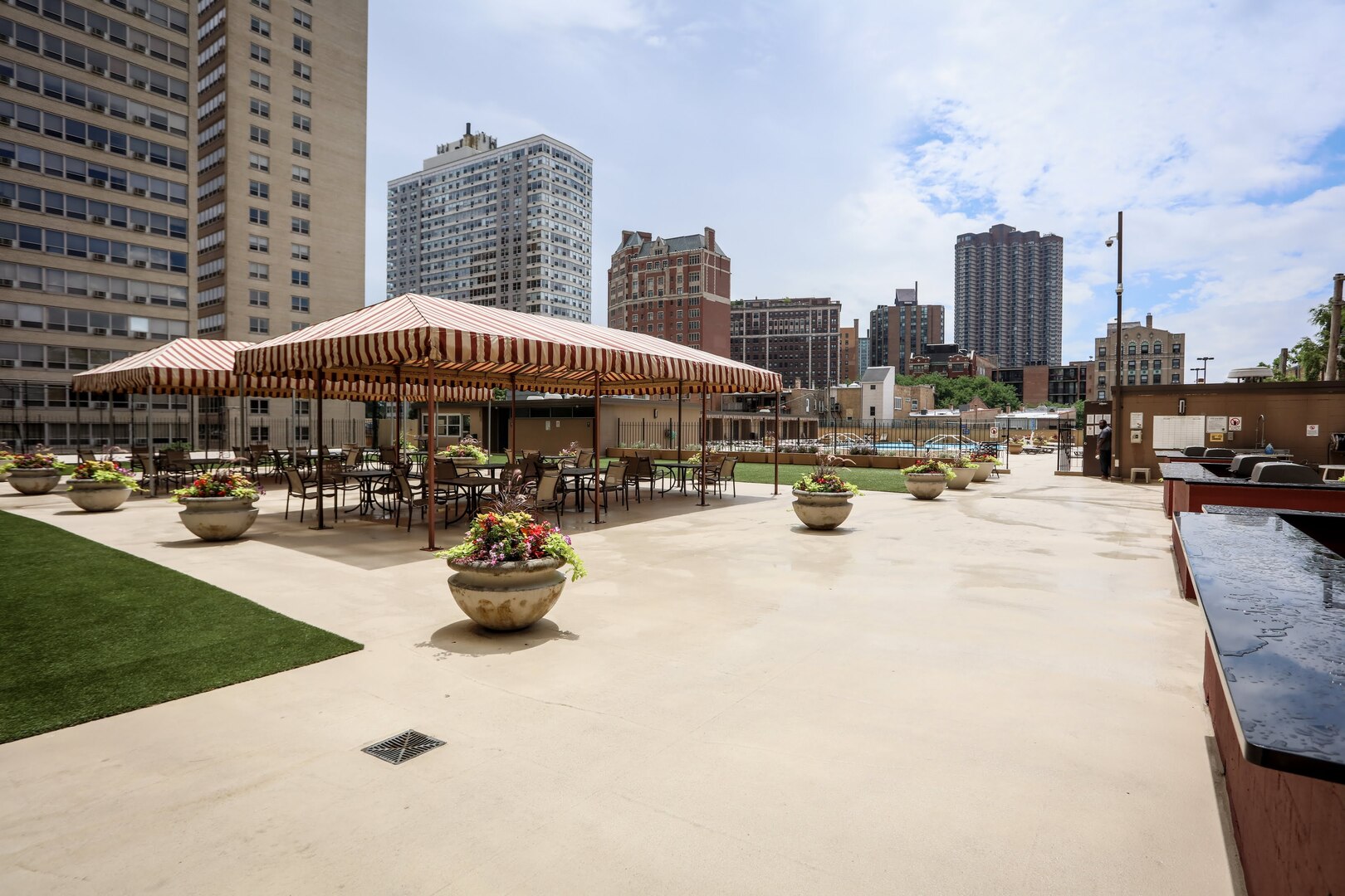 655 West Irving Park Road, Unit 1017 Chicago, IL 60613 - Photo 20 of 24 a swimming pool with outdoor seating and city view