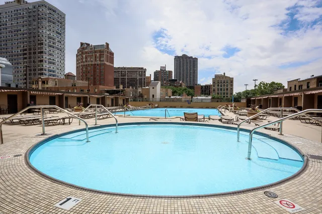 a view of a swimming pool with outdoor seating