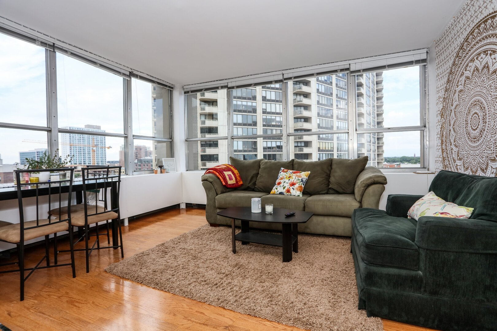 655 West Irving Park Road, Unit 1017 Chicago, IL 60613 - Photo 7 of 24 a living room with furniture and a large window
