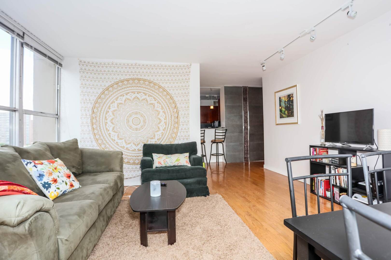 655 West Irving Park Road, Unit 1017 Chicago, IL 60613 - Photo 8 of 24 a living room with furniture and a flat screen tv