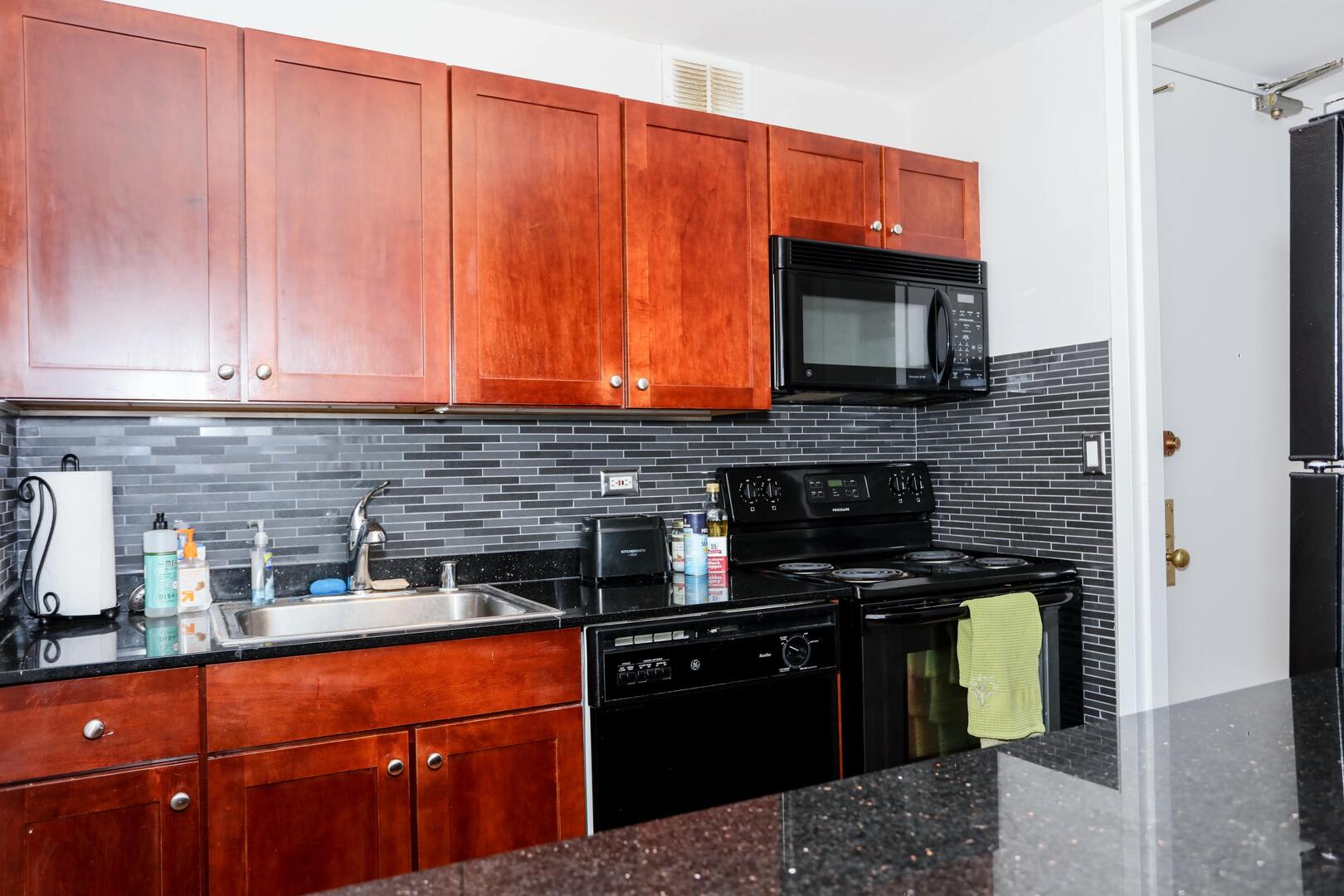 655 West Irving Park Road, Unit 1017 Chicago, IL 60613 - Photo 9 of 24 a kitchen with stainless steel appliances granite countertop a stove and a refrigerator