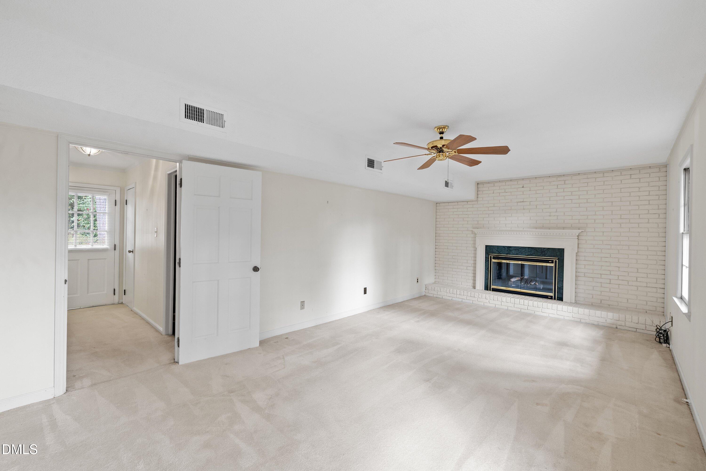 1429 Falls Church Road Raleigh, NC 27609 - Photo 15 of 60 a view of an empty room with a ceiling fan