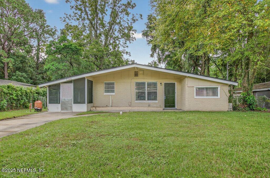 7326 Melvin Road Jacksonville, FL 32210 - Photo 1 of 42 a view of a backyard of the house