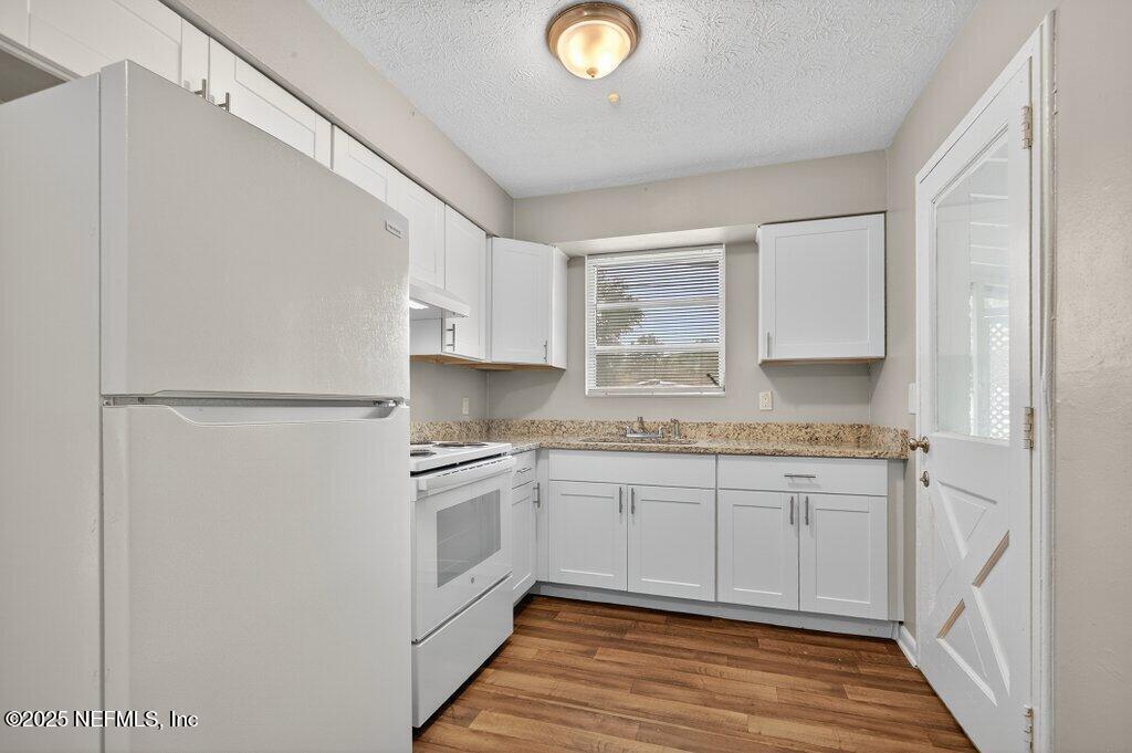7326 Melvin Road Jacksonville, FL 32210 - Photo 14 of 42 a kitchen with stainless steel appliances granite countertop a stove a sink and a refrigerator