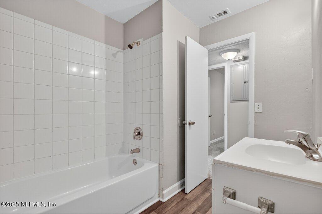 7326 Melvin Road Jacksonville, FL 32210 - Photo 23 of 42 a bathroom with a tub a sink and a mirror