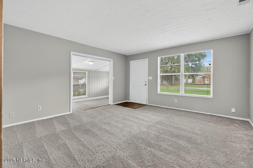 7326 Melvin Road Jacksonville, FL 32210 - Photo 3 of 42 an empty room with windows and closet