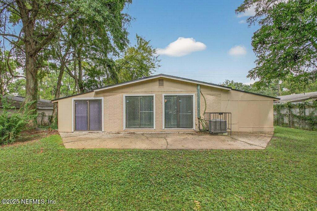 7326 Melvin Road Jacksonville, FL 32210 - Photo 36 of 42 a front view of house with yard and green space