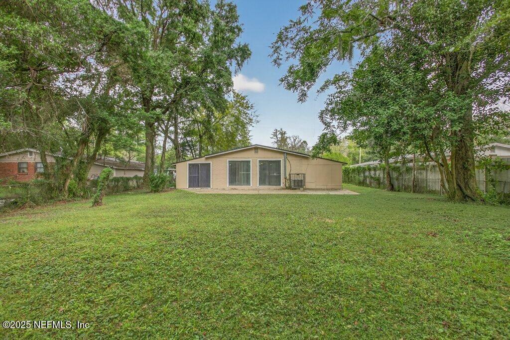 7326 Melvin Road Jacksonville, FL 32210 - Photo 40 of 42 a yellow house in middle of the forest