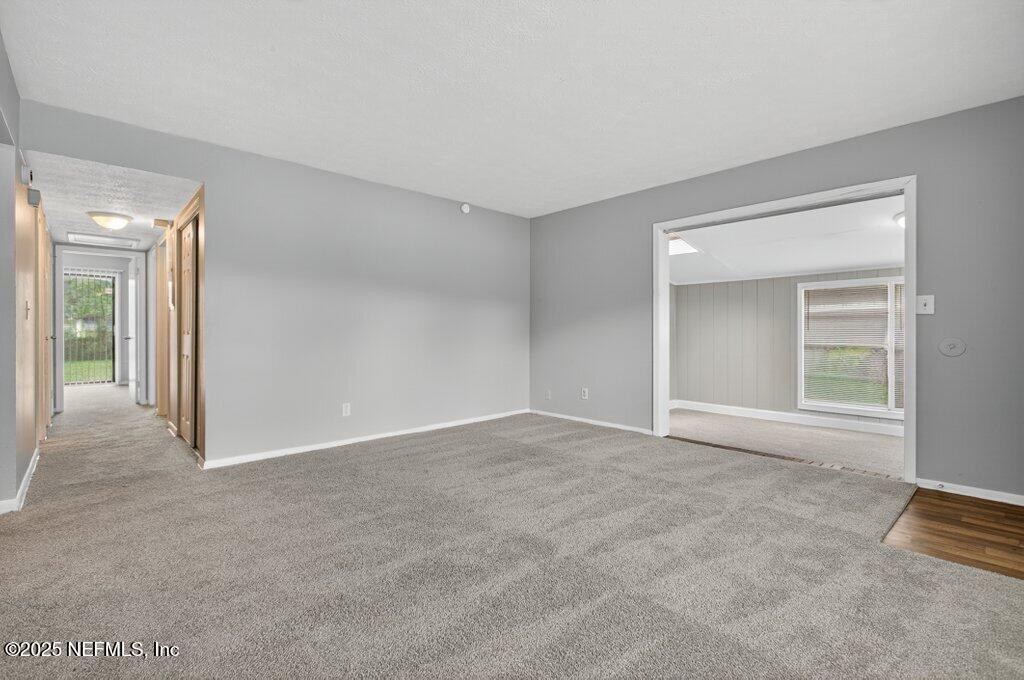 7326 Melvin Road Jacksonville, FL 32210 - Photo 4 of 42 a view of an empty room with a window