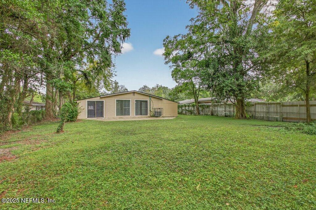 7326 Melvin Road Jacksonville, FL 32210 - Photo 41 of 42 a front view of a house with a yard