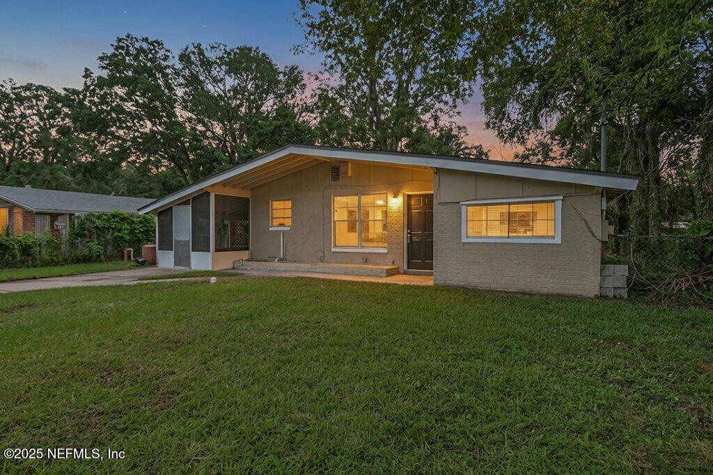 7326 Melvin Road Jacksonville, FL 32210 - Photo 42 of 42 a front view of house with yard and green space