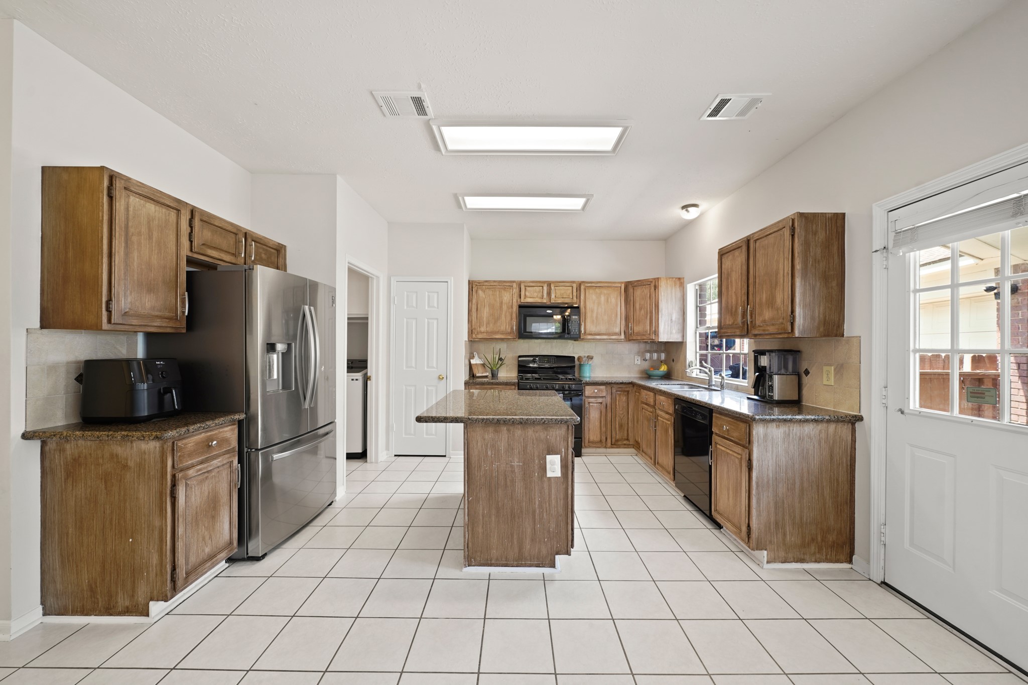 16114 Kintyre Point Road Houston, TX 77095 - Photo 16 of 39 This well designed kitchen has an island, granite countertops, gas cooktop, and abundant work space.