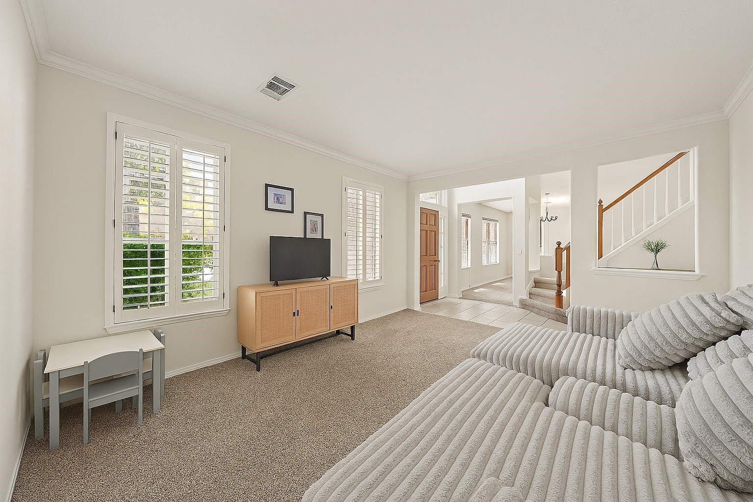 16114 Kintyre Point Road Houston, TX 77095 - Photo 8 of 39 Plantation shutters cover the windows at the front of the home.