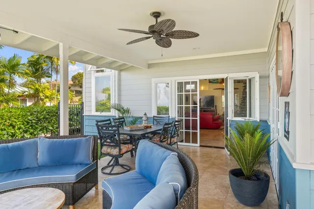 a living room with furniture potted plant and a large window